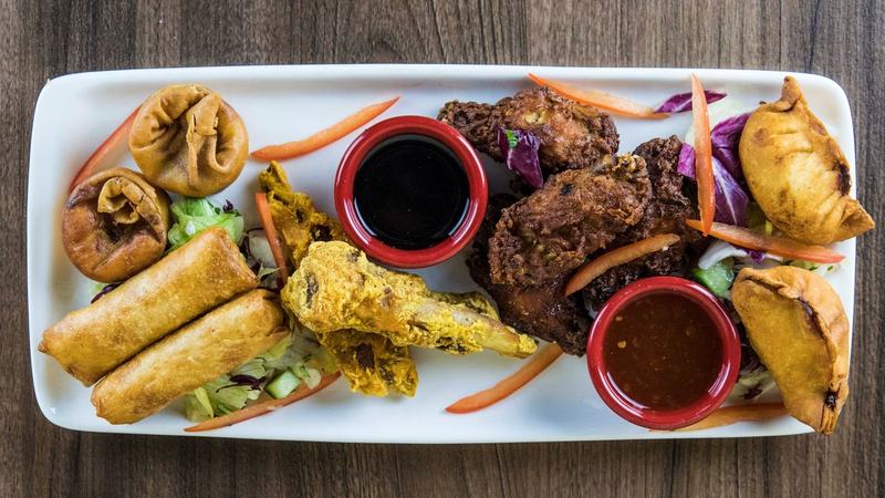 Oriental platter with spring rolls, ribs, wings and dipping sauces