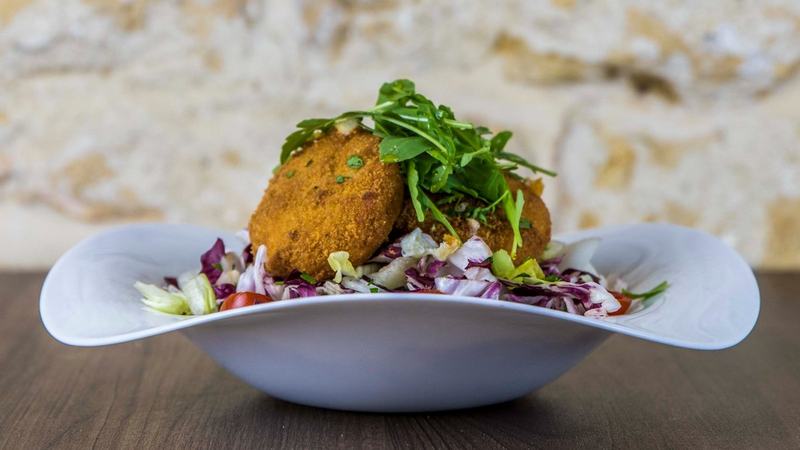 Breaded Gozo cheese served on a crisp green salad